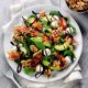 Walnut and pancetta salad in a white bowl