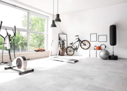 A spacious home gym with an exercise bike and treadmill