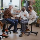 A group of four adults sitting and talking