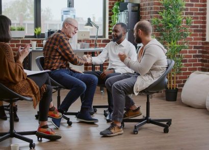 A group of four adults sitting and talking