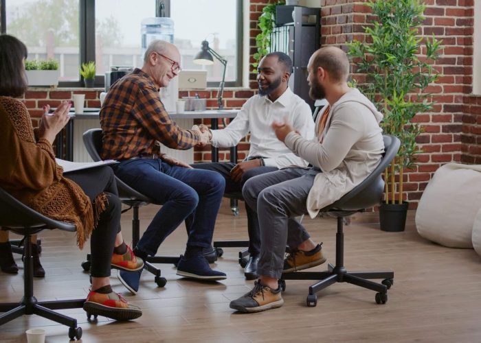 A group of four adults sitting and talking