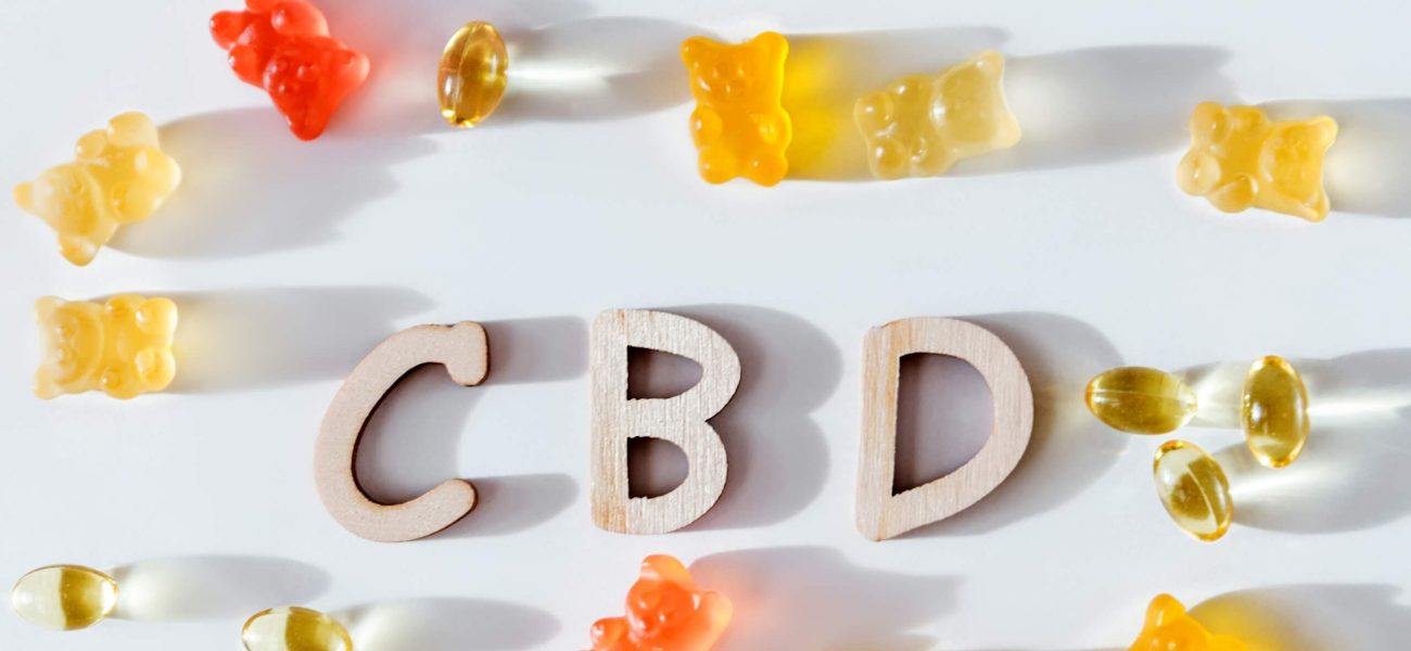 The letters CBD surrounded by CBD gummies