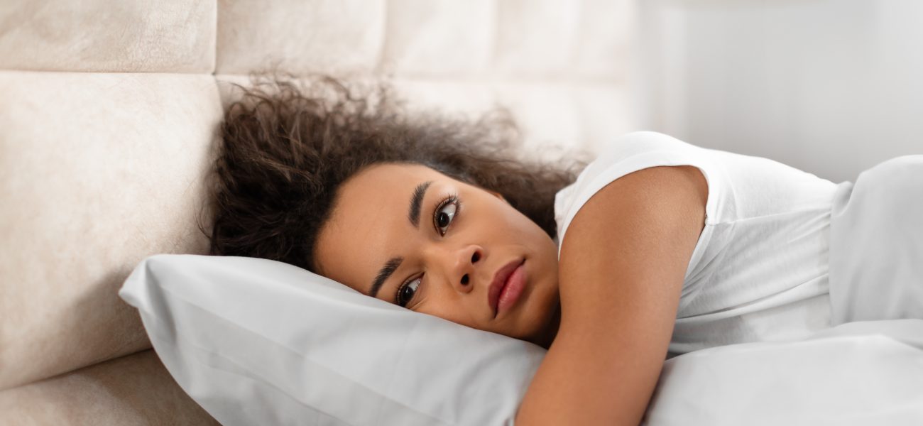 Woman struggling to sleep after having a nightmare