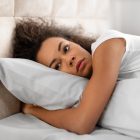 Woman struggling to sleep after having a nightmare