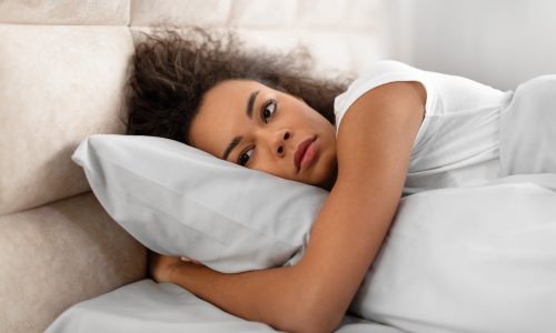 Woman struggling to sleep after having a nightmare