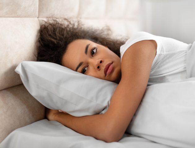 Woman struggling to sleep after having a nightmare