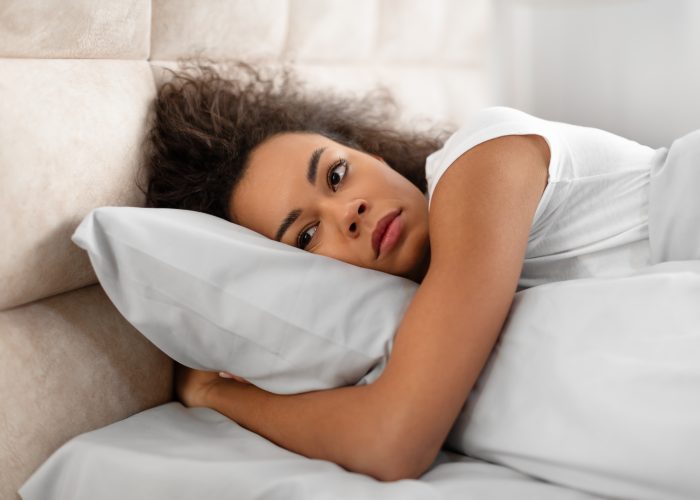 Woman struggling to sleep after having a nightmare