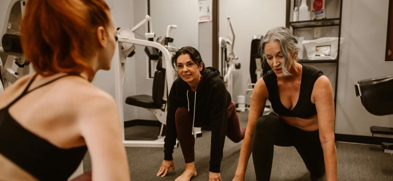 Two women exercising in a gym